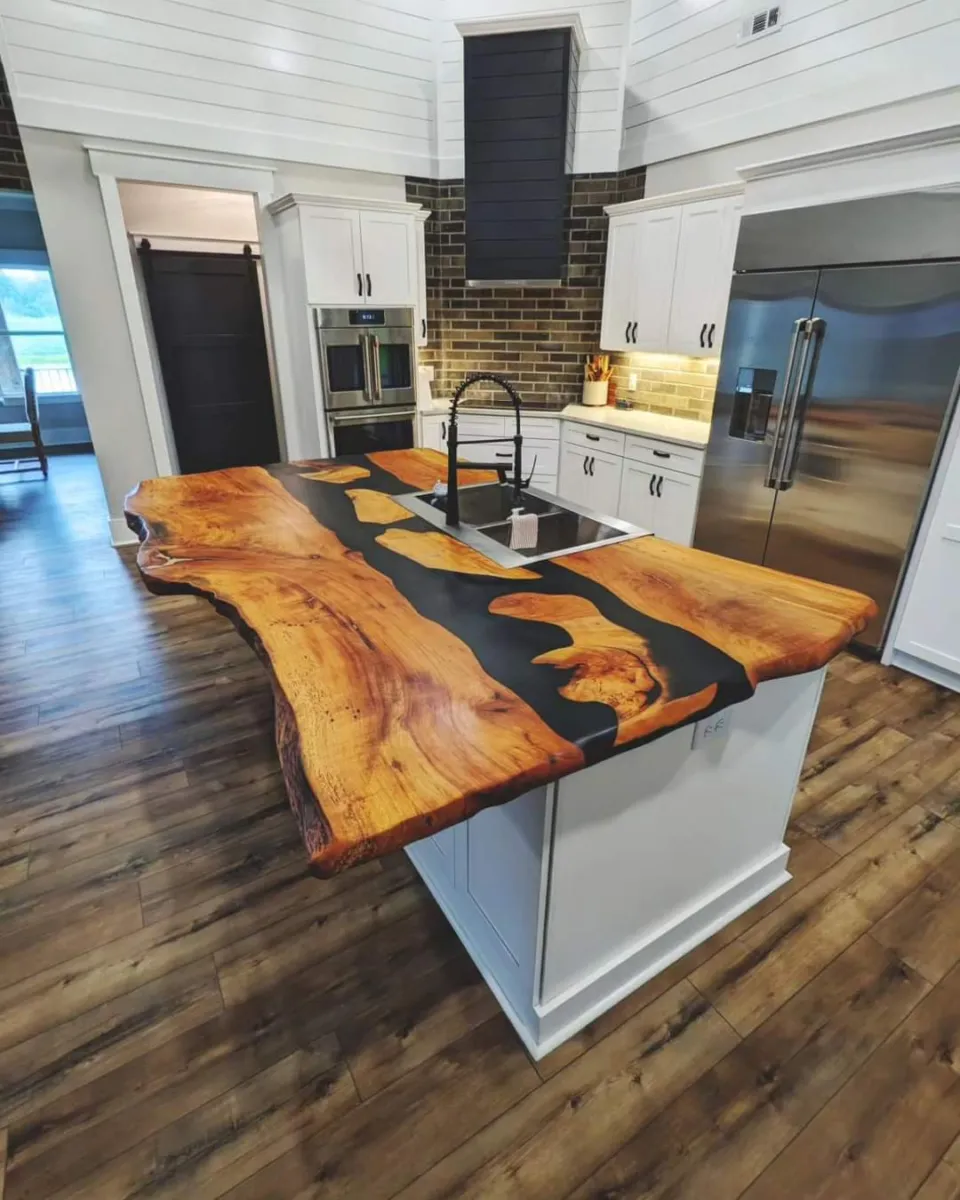 big kitchen island created from large pecan slabs and black epoxy with a matte finish